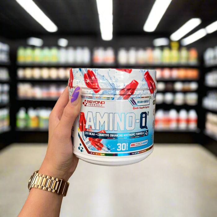 Close-up of (Beyond Yourself AMINO-IQ2 417g) held up inside My Supplement Shop, clearly showing the front label in a Sports Nutrition setting.