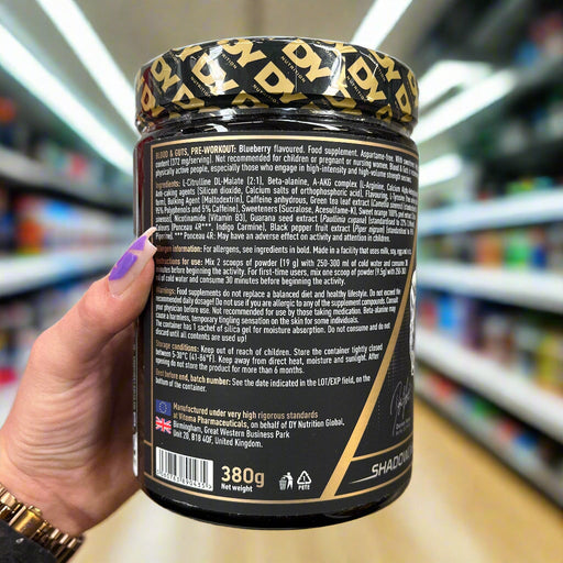 Black jar of DY Nutrition Blood And Guts blueberry pre workout supplement with gold lid