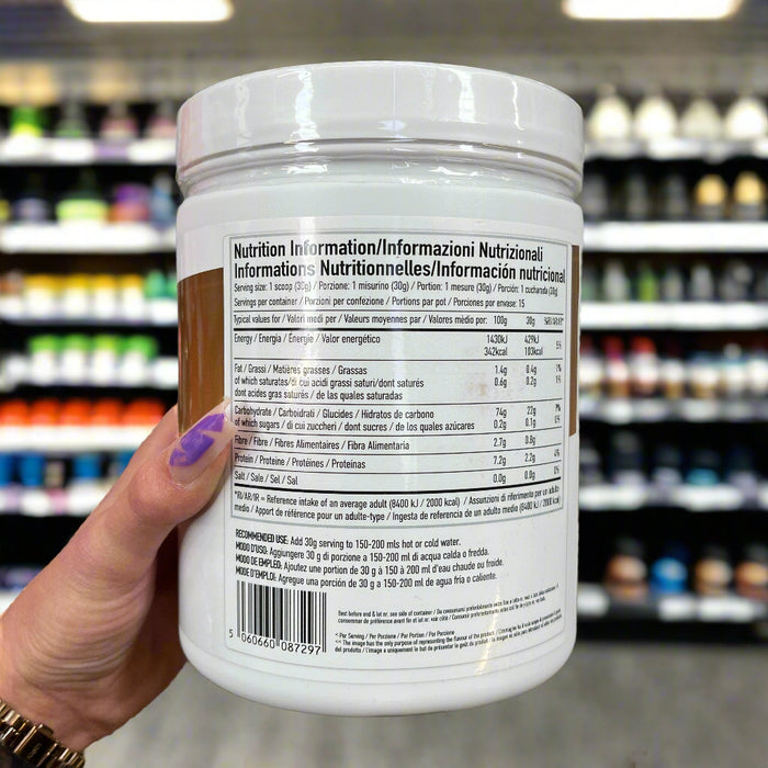 Close-up of (Per4m Cream of Rice 450g – Gluten-Free, Plant-Based Energy Snack) held up inside My Supplement Shop, clearly showing Nutritional Values on the packaging in a Sports Nutrition setting.